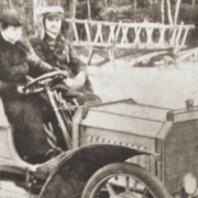 Historische Aufnahme von Ferdinand Porsche in dem ersten Hybridauto der Welt, von ihm entwickelt.