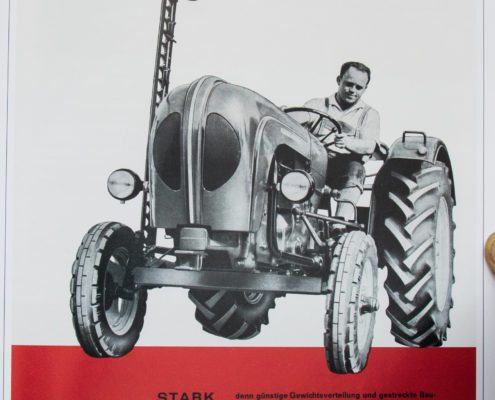 Zeitungsbild zeigt Mann der einer der ersten landwirtschaftlichen Traktoren fährt